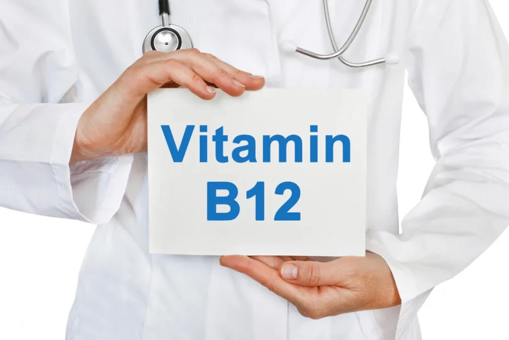 Doctor holding Vitamin B12 card. 