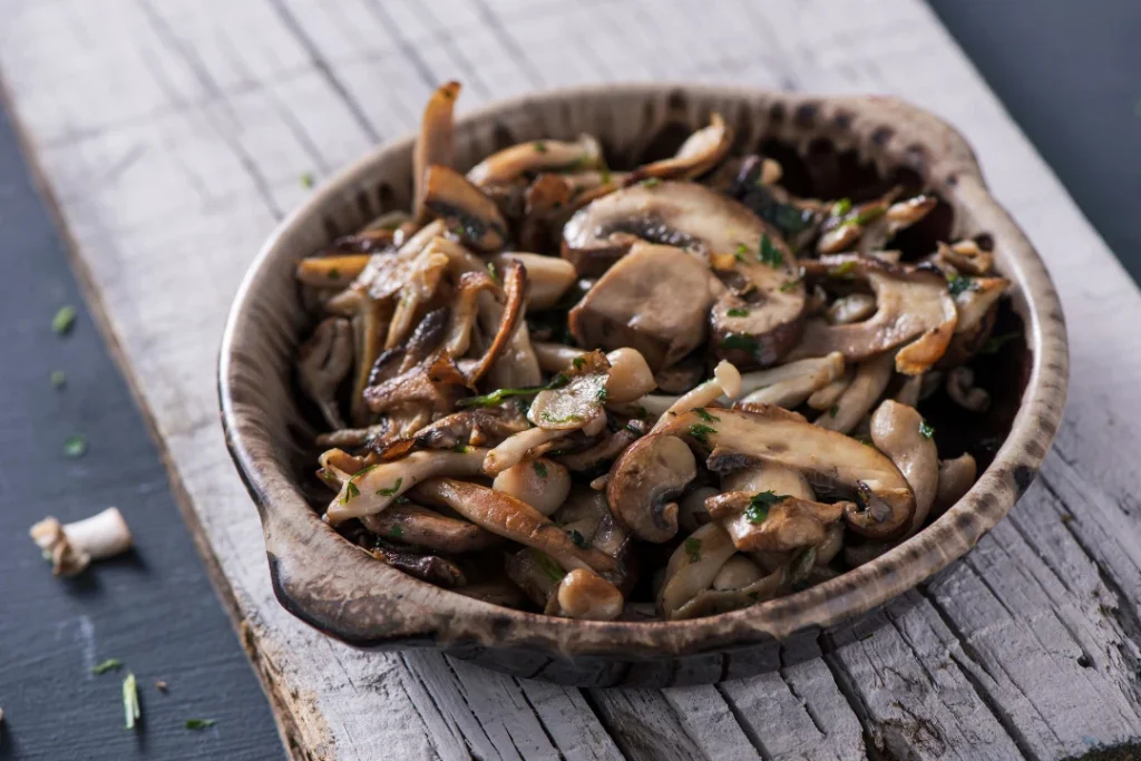 Cooked Mixed Mushrooms in Wooden Bowl. 
