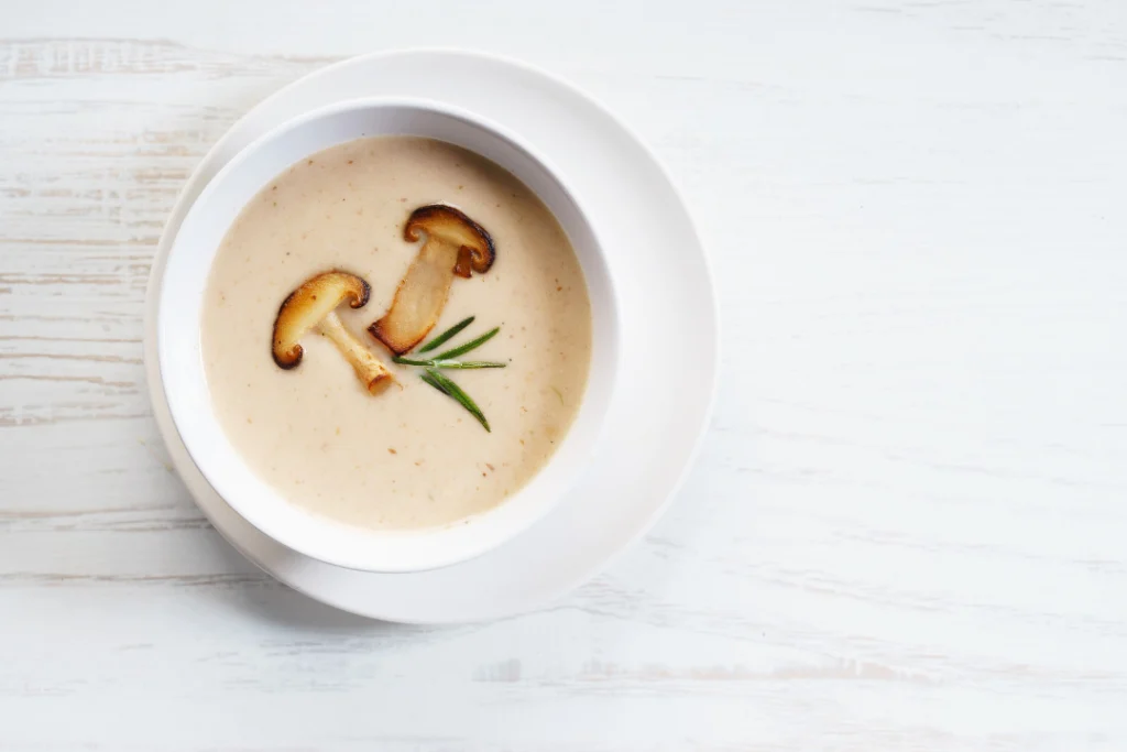 Mushrooms soup on a white table.
Mushroom Soup for health and longevity