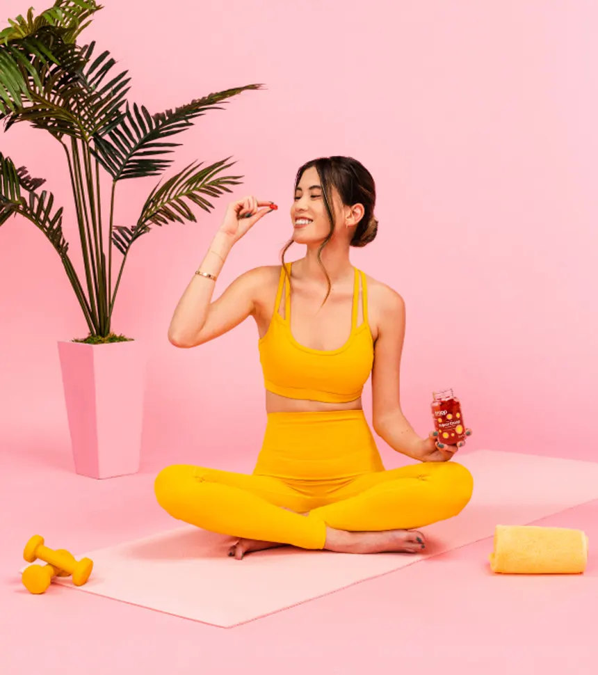 Young attractive girl eating troop mushroom gummies. 