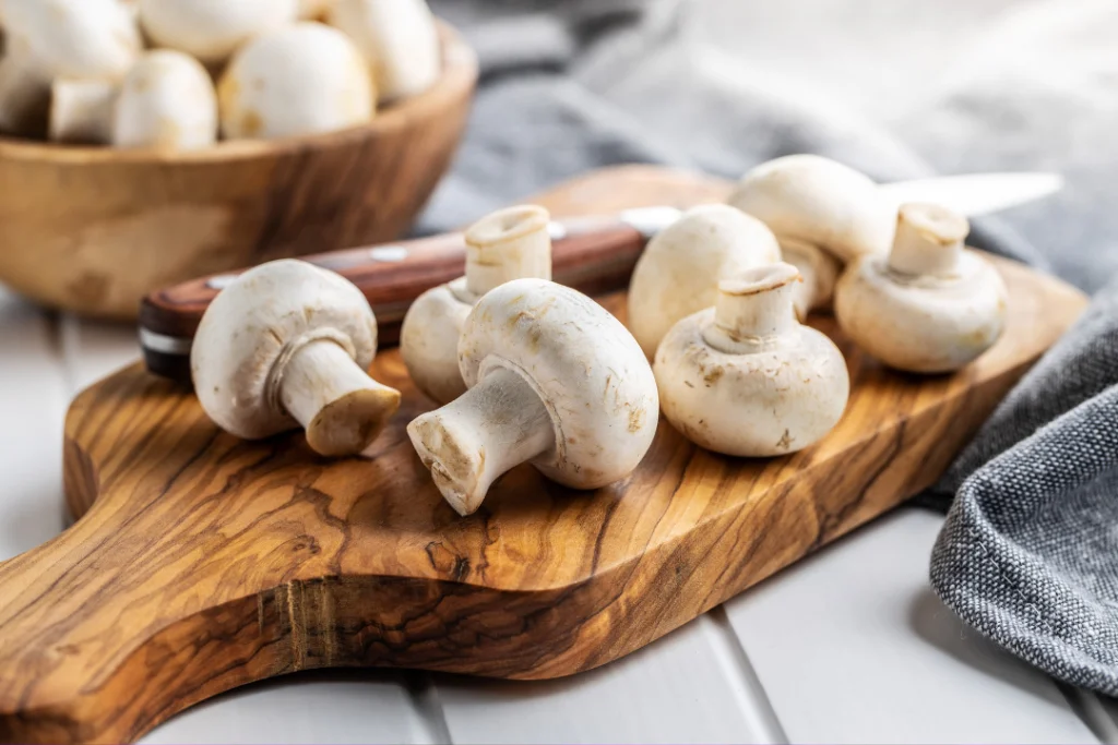 Mushroom on a cutting board with knife a side